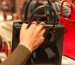 person holding black leather handbag